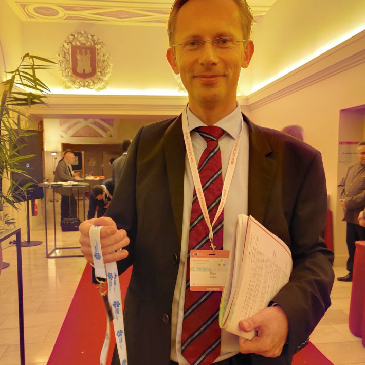 Milan Grohol (Policy Officer, DG GROW) with the FRAME USB stick and lanyard